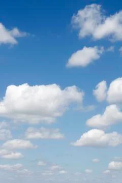 Fluffy clouds in a blue sky Stock Photos