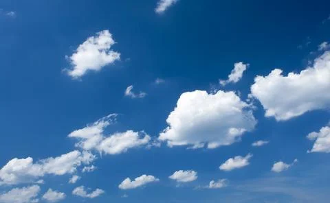 Fluffy clouds on the blue sky Stock Photos