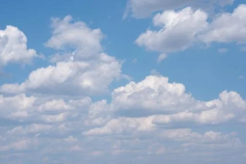 Fluffy clouds on the blue sky Stock Photos