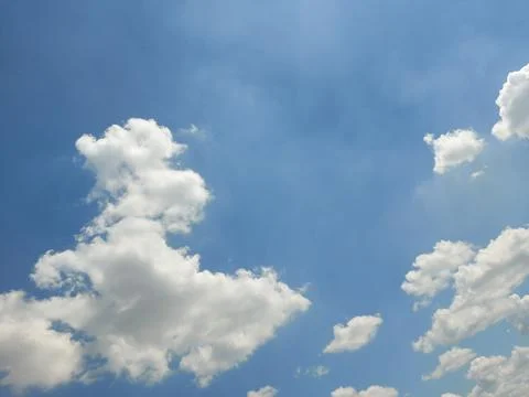 Fluffy clouds on the blue sky Stock Photos