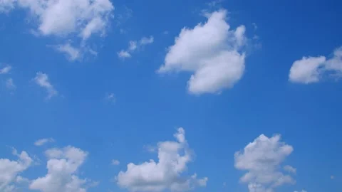 Fluffy clouds in a blue sky on a spring day. 4k60p Stock Footage 132219619