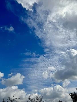 Fluffy Clouds in Bright Blue Sky Stock Photos