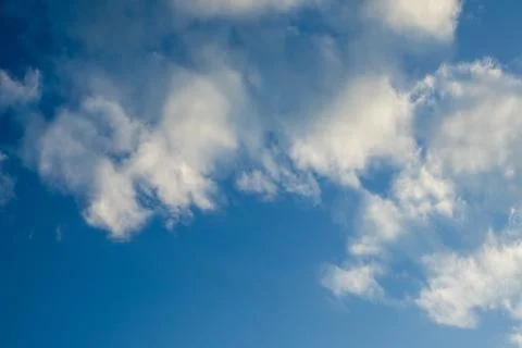Fluffy Clouds in a Bright Blue Sky 스톡 사진