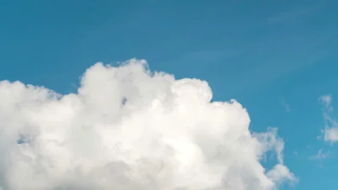 Fluffy clouds on a clear light blue sky Stock Footage 213315351