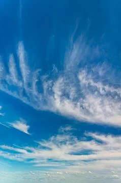 Fluffy clouds on a clear sunny day Stock Photos