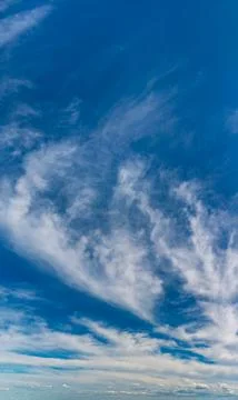 Fluffy clouds on a clear sunny day Stock Photos