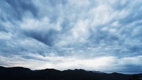 Fluffy clouds floating over mountainous valley Stock Footage 149537044