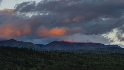 Fluffy clouds flowing over forest hills at sunset 8K time lapse Stock Footage 113998763