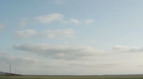 Fluffy Clouds Frozen on the Outgoing Beyond the Horizon Mesh Fence Stock Footage 62509341