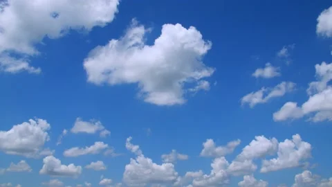 Fluffy clouds hanging in a blue sky on a spring day. 4k60p Stock Footage 132221384