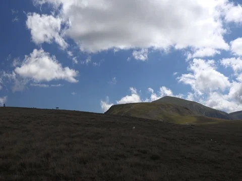 Fluffy clouds mountains dog human silhouettes stock footage Video stock 70960145
