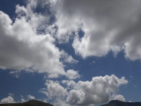 Fluffy clouds mountains dog human silhouettes stock footage Stock Footage 70960259