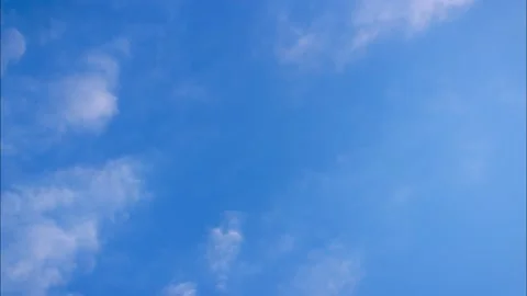 Fluffy clouds movement on blue sky Stock Footage 131375188