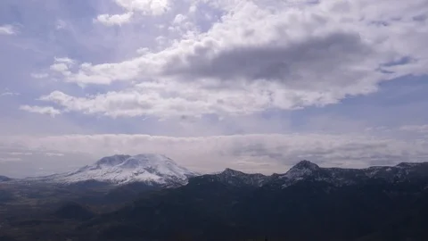 Fluffy clouds over Mount St. Helens on a sunny day Stock Footage 99086716