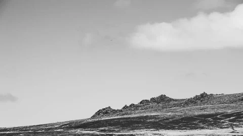 Fluffy clouds over Rocks Preseli Hills Pembrokeshire Black and White Timelapse Stock Footage 90384685