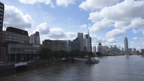 Fluffy clouds over Thames riverside with office buildings. Stock Footage 110911373