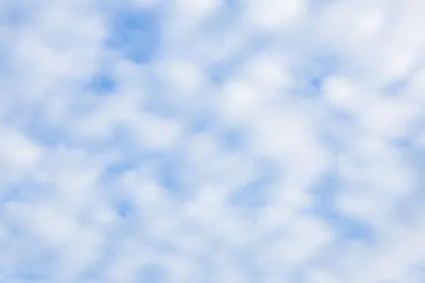 Fluffy Clouds in a Pale Blue Sky 스톡 사진