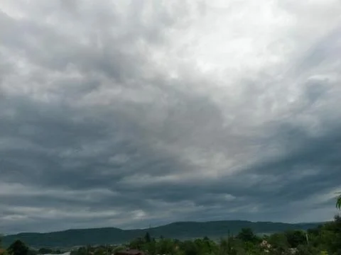 Fluffy clouds on the sky. cloudy day in the forest Stock Photos
