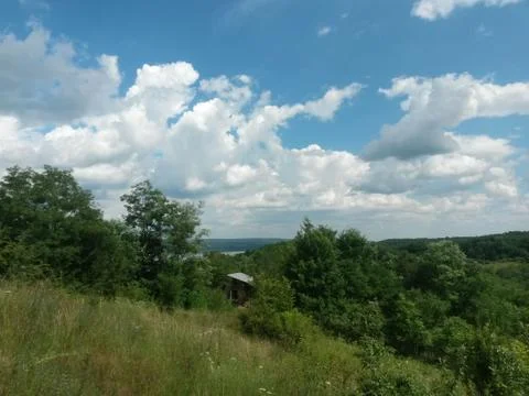 Fluffy clouds on the sky. cloudy day in the forest Stock Photos
