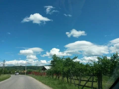 Fluffy clouds on the sky. cloudy day in the forest Stock Photos