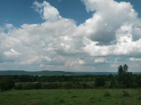 Fluffy clouds on the sky. cloudy day in the forest Stock Photos