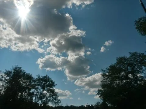Fluffy clouds on the sky. cloudy day in the forest Stock Photos