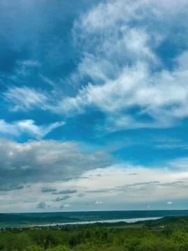 Fluffy clouds on the sky. cloudy day in the forest Stock Photos
