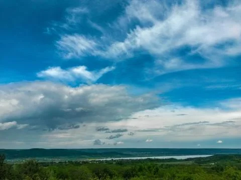 Fluffy clouds on the sky. cloudy day in the forest Stock Photos