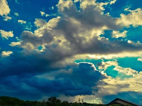 Fluffy clouds on the sky. cloudy day in the forest Stock Photos