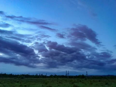 Fluffy clouds on the sky. cloudy day in the forest Stock Photos