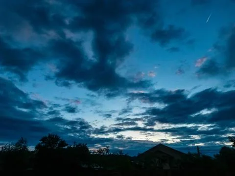 Fluffy clouds on the sky. cloudy day in the forest Stock Photos