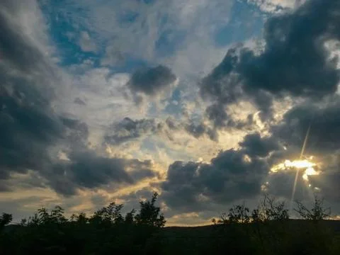 Fluffy clouds on the sky. cloudy day in the forest Stock Photos