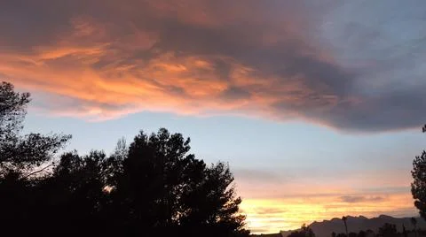 Fluffy Clouds At Sunset Stock Photos