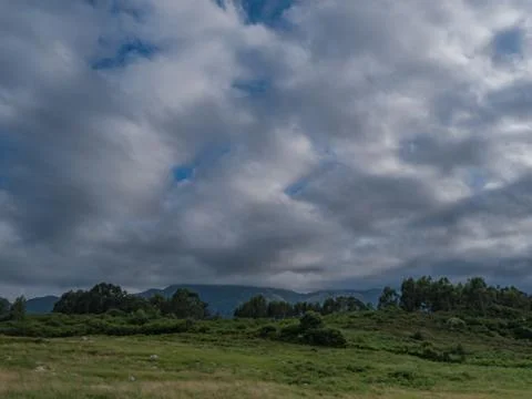 Fluffy clouds through which you can see a blue sky Stock Photos