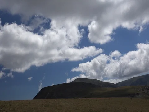 Fluffy cloudsmountains 4k Stock Footage 70960432