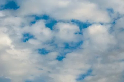 Fluffy cloudy sky background. Blue cumulus cloud Stock Photos