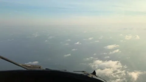 Fluffy cloudy sky with an ocean below Stock Footage 131843777