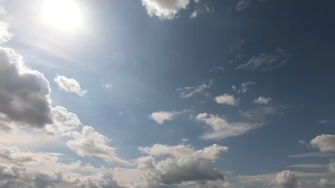 Fluffy cumulus clouds are appearing, growing, and disappering in the blue sky. Video stock 107420114