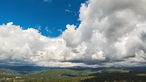 Fluffy Cumulus Clouds Form and Re-Form over Sierra Nevada Mtns. in California Stock Footage 279299586