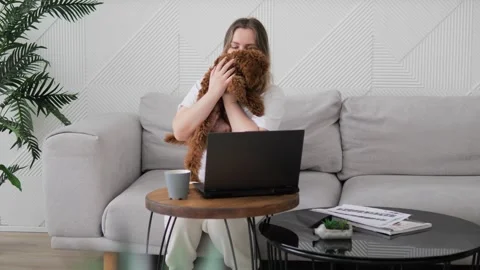 Fluffy cute toy poodle asks to be held by owner wagging tail. Woman happily Stock Footage 267595311