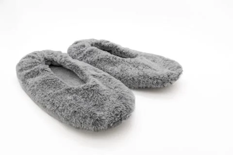 Fluffy gray home slippers isolated on white background Foto stock