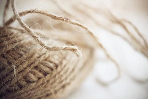 Fluffy the hemp thread is gathered into a ball. The tip of the thread stickin Stock Photos
