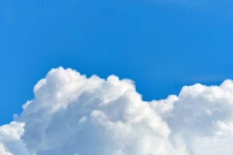 Fluffy more clouds in the blue sky with copy space. Stock Photos