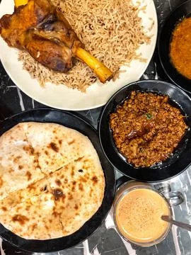 Fluffy nan bread served with condiments in a Pakistani restaurant. Stock Photos