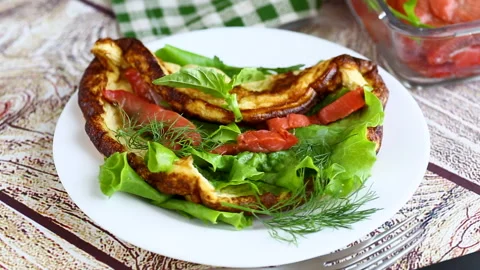 Fluffy omelet with red fish and fresh vegetable salad Stock Footage 340105335