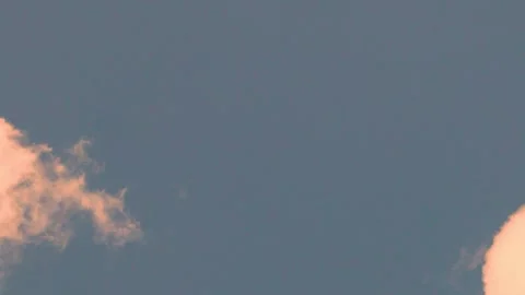 Fluffy orange yellow clouds fly away and remain pure sunset blue sky cloudless t Video stock 313526860