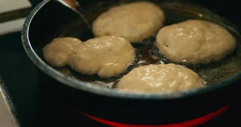 Fluffy pancakes are fried in vegetable oil in frying pan Stock Footage 231504999