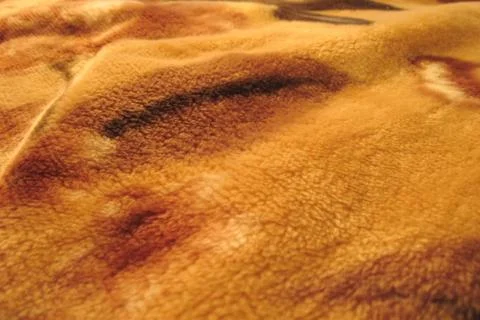 Fluffy piled waved fabrics texture. Abstract orange brown nappy background Stock Photos
