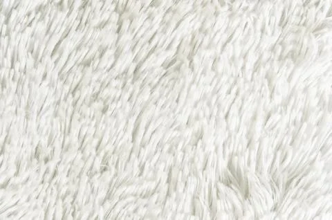 Fluffy plaid of polyester with a long heap gray. Comfortable home textiles. Stock Photos