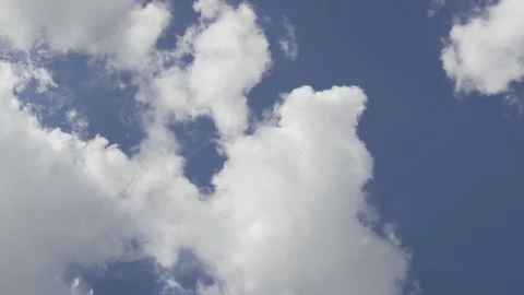 Fluffy Plump Clouds Cover the Blue Sky in Clear Daytime Weather. Background of C Stock Footage 138151084